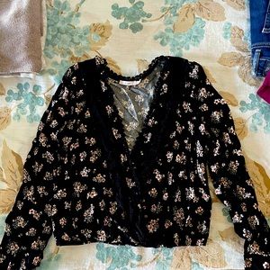 Black blouse with flowers.